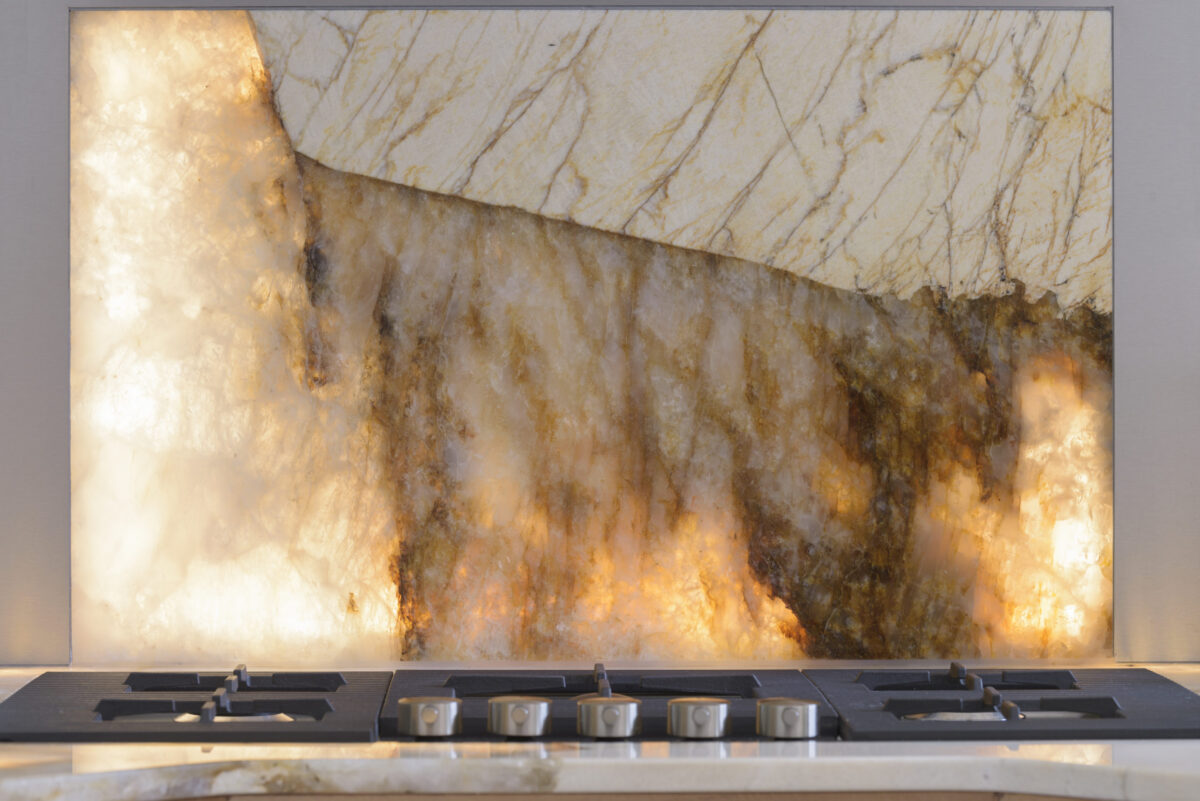 Crédence en granit Patagonia rétroéclairée dans une cuisine en bois clair