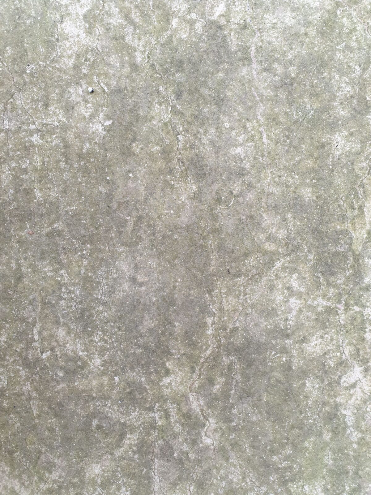Surface grise texturée en gros plan, aspect minéral