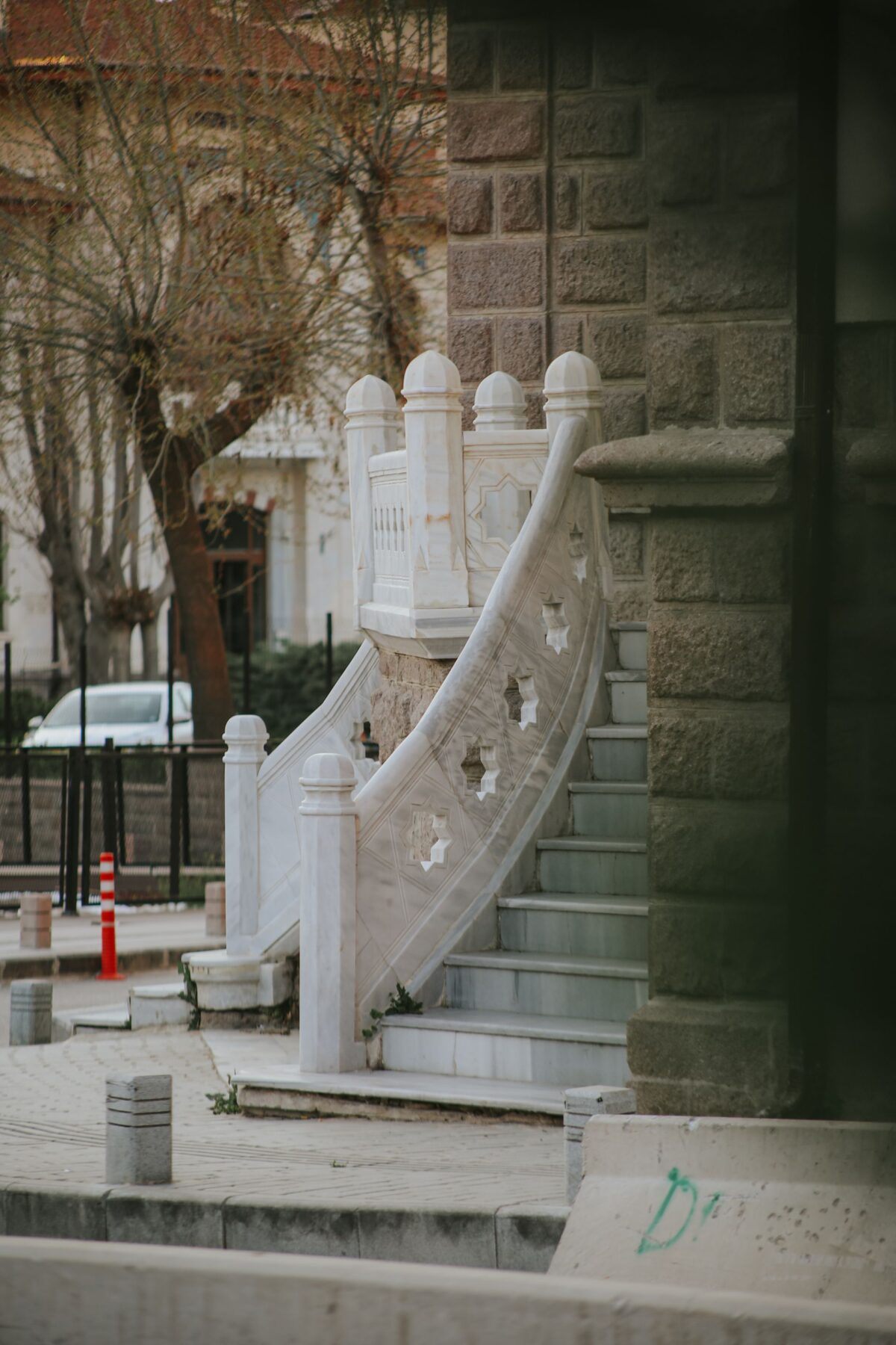 Escalier extérieur en pierre blanche à limon et balustrade ajourée