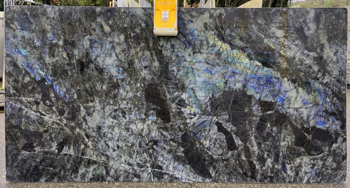 Tranche de labradorite bleue aux éclats irisés sur fond sombre